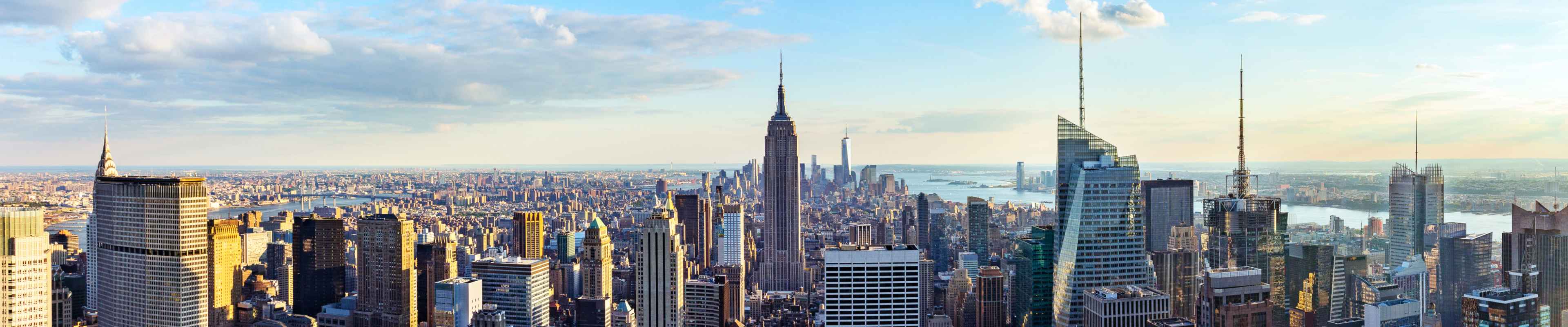 New York City skyline from roof top with urban skyscrapers before sunset.New York, USA. Panorama image